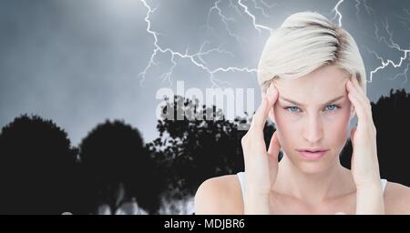 Lightning strikes and stressed woman with headache holding head Stock Photo