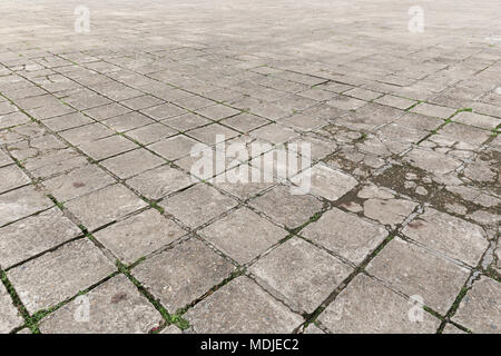 Full frame background of old and weathered cement paving slabs outdoors Stock Photo