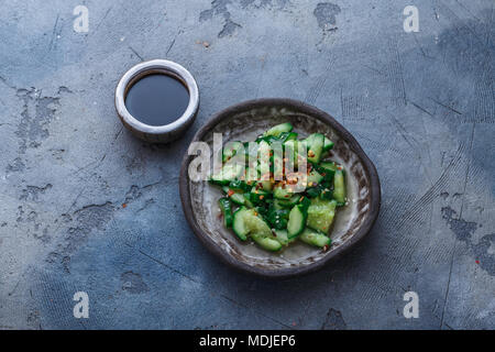 Chinese beaten cucumbers salad, top view, dark background, copy space Stock Photo