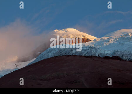 Walls of ice on the glacier of Cotopaxi, Summit and Yanasacha Rock wall at dusk Stock Photo