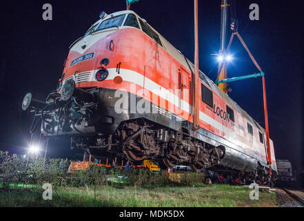 19 April 2018, Germany, Gadebusch: Two cranes lift a 78 tonne diesel locomotive of the model V-180 into the railway museum outside the local train station. The so-called 'cigar' locomotive was built in 1967. Photo: Jens Büttner/dpa-Zentralbild/dpa Stock Photo