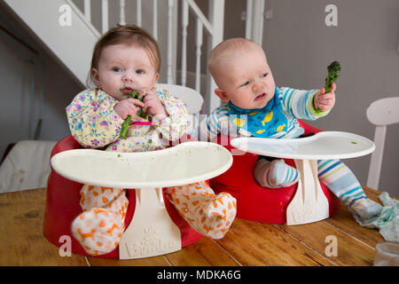 babies eating broccoli age 6 months Stock Photo