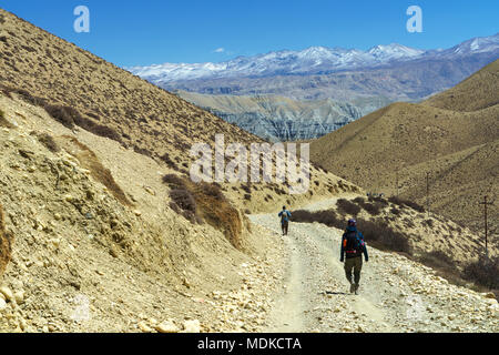 Two trekkers traveling on the trail between Geling and Ghemi, Upper Mustang region, Nepal. Stock Photo