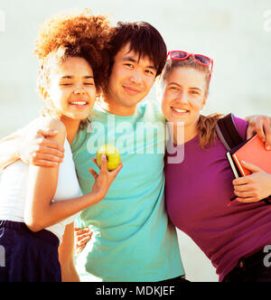 cute group of teenages at the building of university with books huggings Stock Photo