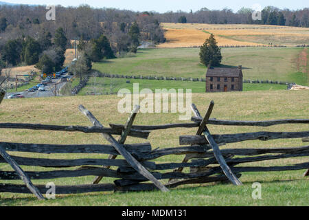 Modern traffic clogs Sudley Rd, at left, the Stone House and split rail fences at right are part of the Manassas National Battlefield Park, scene of f Stock Photo