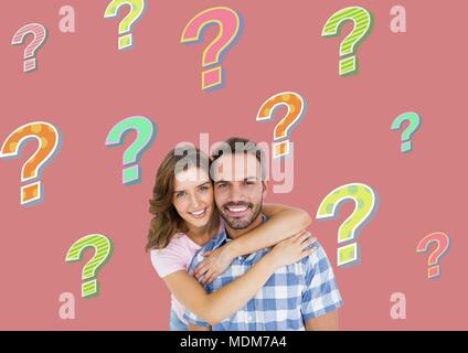 Happy couple with colorful funky question marks Stock Photo