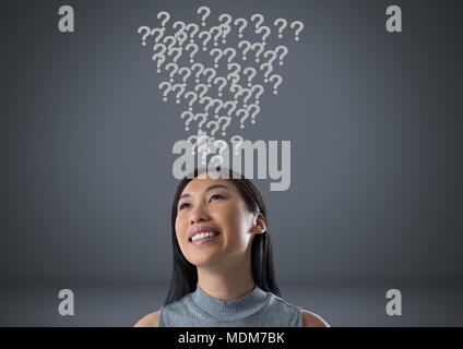 Woman with grey question marks emerging from head Stock Photo