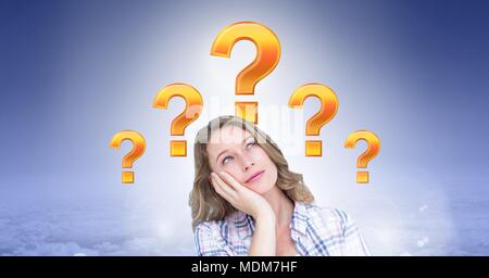 Woman thinking with gold question marks in clouds Stock Photo