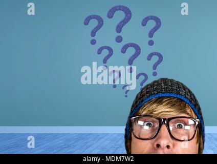 Man in hat thinking with blue stitched question marks Stock Photo