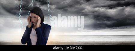 Lightning strikes and stressed woman with headache holding head Stock Photo
