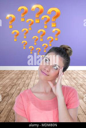 Woman thinking with gold question marks Stock Photo