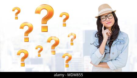 Woman thinking with gold question marks Stock Photo