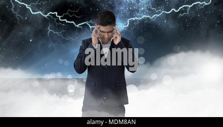 Lightning strikes and stressed man with headache holding head Stock Photo