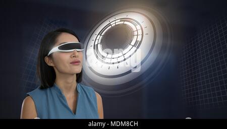Woman with virtual reality headset and Glowing circle technology interface Stock Photo