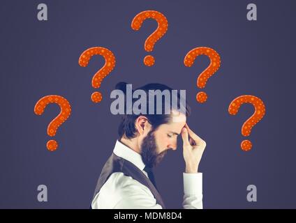 Man thinking with purple stitched question marks Stock Photo