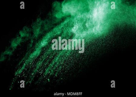 green color powder explosion cloud isolated on black background.