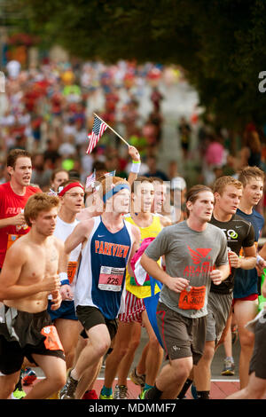 Finish line of a small 10K race with the last few runners crossing ...