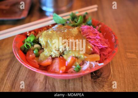 Ingredients of Indonesian food Gado Gado are rice noodles, tofu, chicken, fresh green chives, tomato slices, peanut sauce and satay sauce Stock Photo