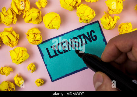 Word writing text Licensing. Business concept for Grant a license Legally permit the use of something Allow activity written by Man Sticky note paper  Stock Photo