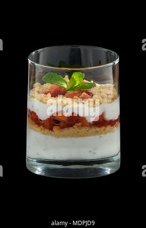 healthy dessert with strawberries and biscuits covered with cream in a glass Stock Photo