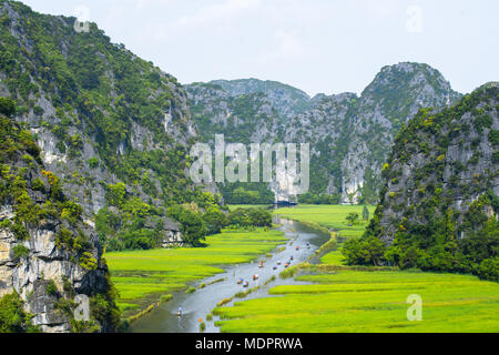 Tourist ride boat for travel sight seeing Rice field on river 'Ngo Dong' at TamCoc, Ninhbinh, Vietnam; Stock Photo