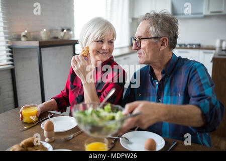 Portrait of happy senior couple having morning talk during breakfast Stock Photo