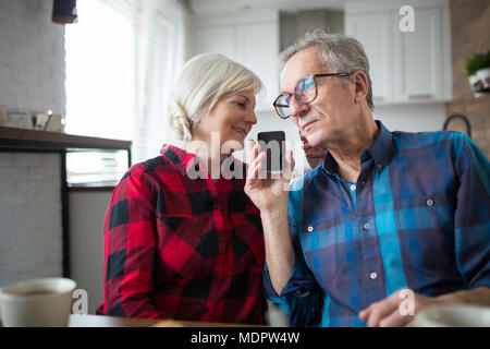 Portrait of senior couple having phone conversation together Stock Photo