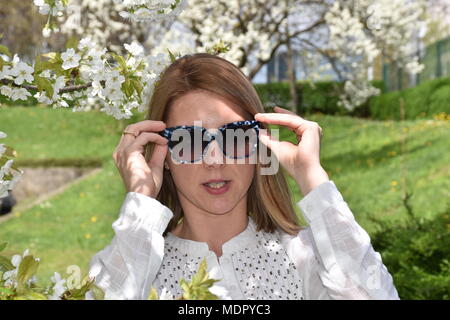 Young woman posing with cherry tree Stock Photo