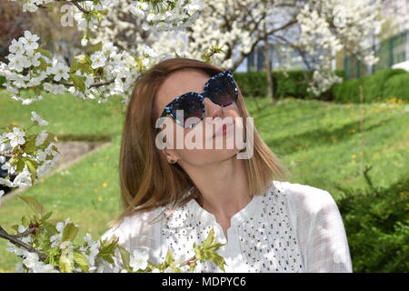 Young woman posing with cherry tree Stock Photo