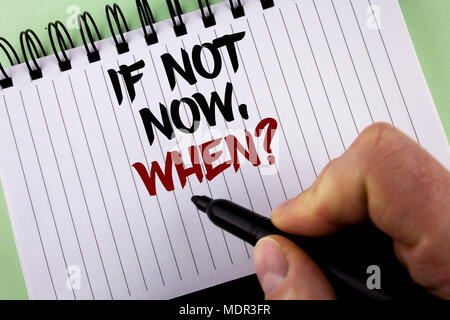 Text sign showing If Not Now When Question. Conceptual photo asking about time Putting plan To do list written by Man Notepad holding Marker the plain Stock Photo