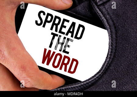 Handwriting text Spread The Word. Concept meaning Run advertisements to increase store sales many fold written Mobile Screen holding in the Hand Jeans Stock Photo