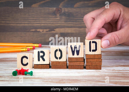 Crowd concept. Wooden letters on the office desk, informative and communication background Stock Photo
