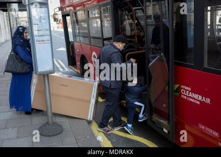 A family load a large box on to a London bus in Aldwych in centrlal London, on 17th April 2018, in London, England. Stock Photo
