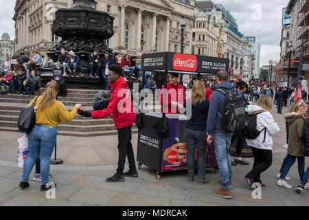 Marketing workers with Coca-Cola hand out samples of their new Zero Sugar (Sugar Free) drinks to passers-by in Piccadilly Circus, on 16th April 2018, in London, England. Stock Photo