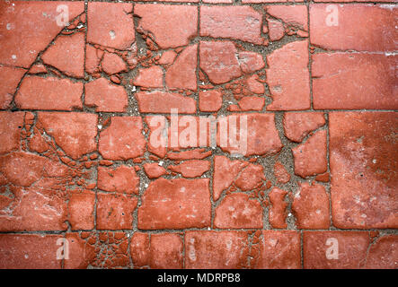 Old terracotta cracked and broken tiled floor. Stock Photo