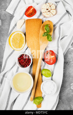 Kitchen utensils and various spices, herbs and vegetables on gray background. Top view. Food background Stock Photo