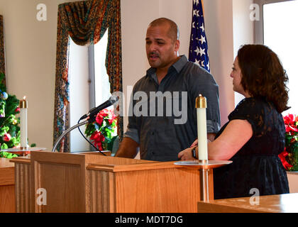 171201-N-GN619-039 Portsmouth, Va. (Dec. 1, 2017) – Senior Chief Aviation Ordnanceman Hiran Carrero Jr. and Personnel Specialist 1st Class Stacie Carrero, parents of the late Sophia Rose and Jocelynn Soelise Carrero, share their story of loss during the Perinatal Bereavement Candle Lighting Remembrance Service. The service included the sharing of music, words of encouragement, prayers of hope and candles lit in honor and memory of infants who have passed for various reasons. (U.S. Navy photo by Mass Communication Specialist 2nd Class Kris R. Lindstrom) Stock Photo