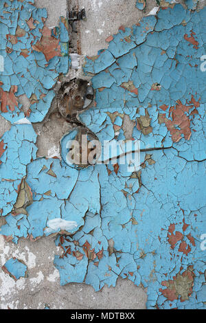 Old wall of house with natural multicolor oil paint shelling. Textured background. Stock Photo