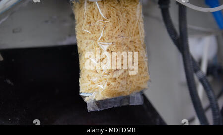Food industry - packing of macaroni in plastic bags Stock Photo