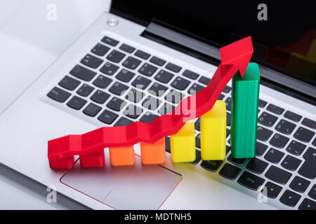 Close-up Of Graph And Arrow Sign Showing Upward Direction On Computer Keyboard Stock Photo