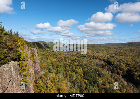 A blue sky with white puffy clouds set the scene as the Big Carp River wends its way towards Lake of the Clouds at Porcupine Mountains, in the U.P. Stock Photo
