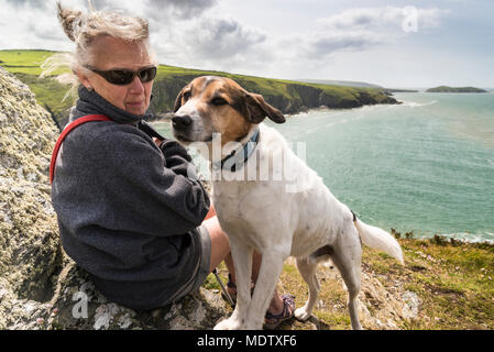 Walking the dog on Foel y Mwnt with Ceredigion coast and Cardigan Bay in the background Stock Photo