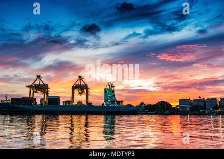 Cargo ship terminal at twilight scene, Unloading crane of cargo ship ...