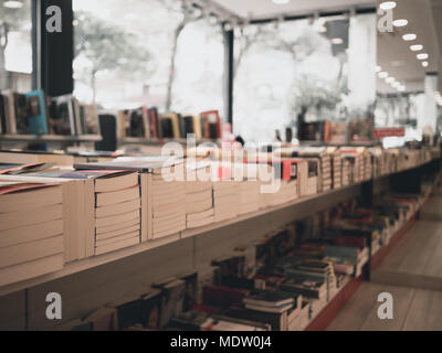 Rimini, Italy- March 09, 2018 new books are on long shelf in bookshop white background Stock Photo