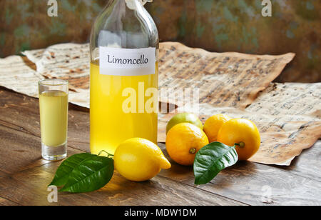 Italian alcoholic beverage, Limoncello on wooden table Stock Photo