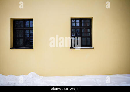 Modern yellow street wall with two windows Stock Photo