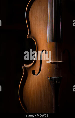 Detail of artisan violin on a black background. Stock Photo