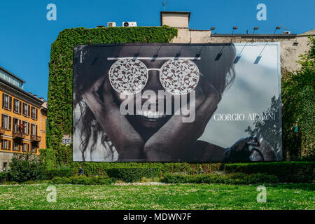 Milan, Italy - April 17, 2018: Illustrative editorial of giant Giorgio Armani advertisement on wall facade Stock Photo
