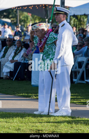 171207-N-YW024-0239 PEARL HARBOR (Dec. 7, 2017) Lt. Cmdr. Michael Genta assists Chief Storekeeper (ret.) Al Rodrigues as he leads the ceremony in rendering honors to the USS Arizona crew still entombed inside the ship during the 76th Anniversary of the attacks on Pearl Harbor and Oahu at Joint Base Pearl Harbor-Hickam. The 76th commemoration, co-hosted by the U.S. Military, the National Park Service and the State of Hawaii, provided veterans, family members, service members and the community a chance to honor the sacrifices made by those who were present Dec. 7, 1941, as well as throughout the Stock Photo