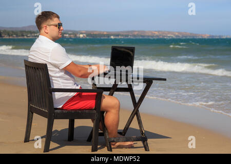 Business Man Working on Tropical Beach Stock Photo